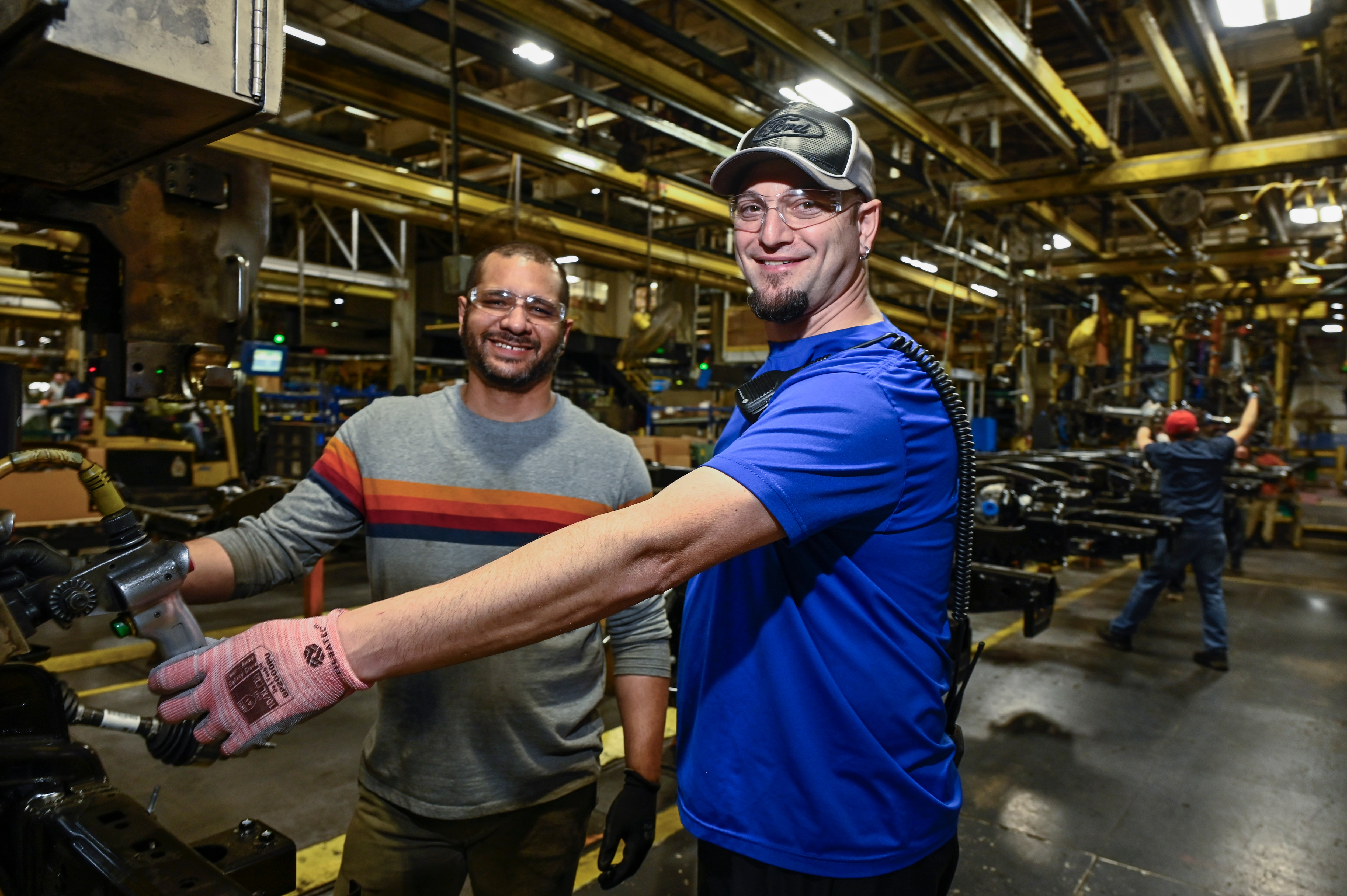 Two Ford employees at the Kansas City Assembly Plant assemble an F-150